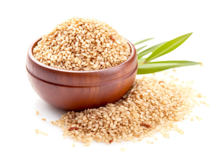 Pile of brown rice in wooden bowl isolated on white background. Close up.の素材
