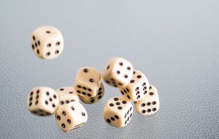 Several dice fall through the air