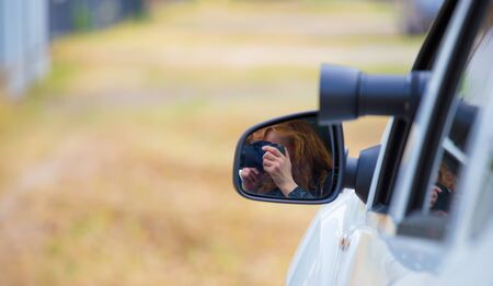 A woman secretly photographed from a car