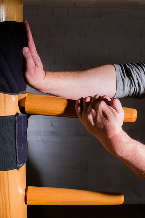 Martial arts training on a wooden dummyの写真素材