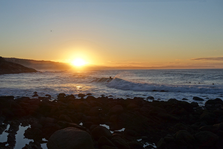 Surfer on wave, sunrise, south africaの写真素材