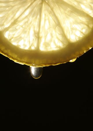 detail of a lemon slice with juice dropの写真素材