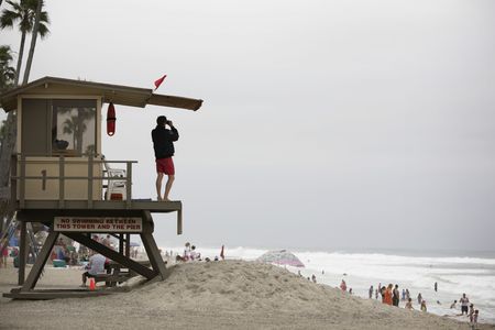 lifeguard observing a beach scene in californiaの写真素材