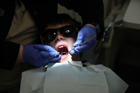 young boy getting a examination at the dentistの写真素材