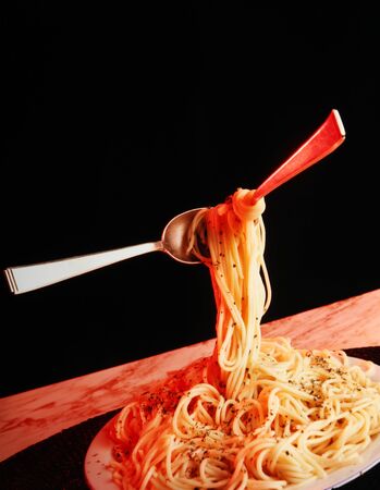 spaghetti on a plate with fork and spoon の写真素材