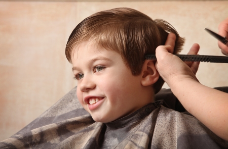 cute young boy getting a haircutの写真素材
