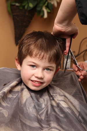cute young boy getting a haircutの写真素材