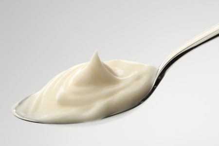 mayonnaise on a spoon with white backgroundの写真素材