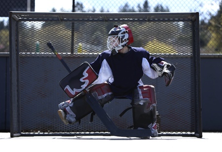 young boy playing street hockey