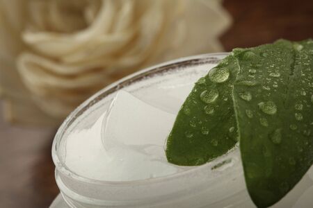 pot of cosmetic creme on a wooden surfaceの写真素材