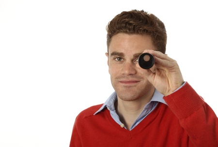young man looking through a telescopeの写真素材
