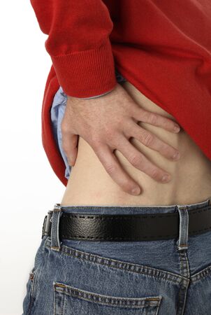 closeup of a man touching his back in painの写真素材