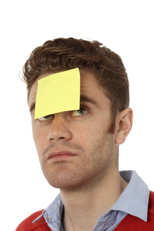 young man with emty post it on his foreheadの写真素材