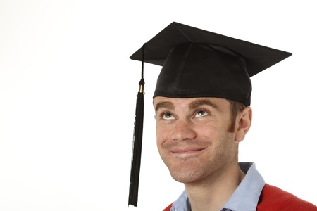 portrait of a young man looking up to his graduation hatの写真素材