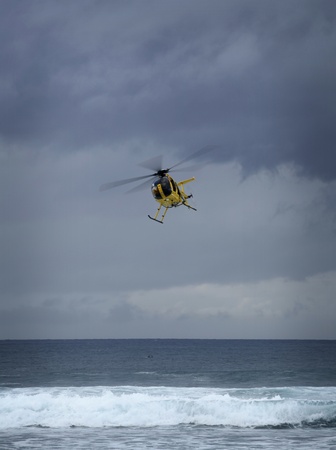 yellow rescue helicoptor over the oceanのeditorial素材