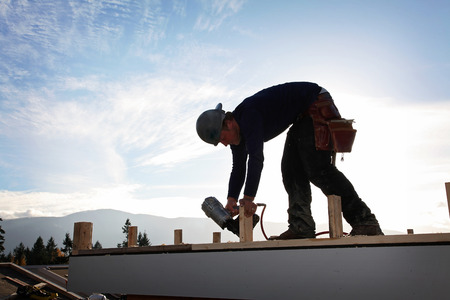A carpenter working on a consruction siteの写真素材