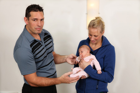 A chiropractor treating a new born babyの写真素材