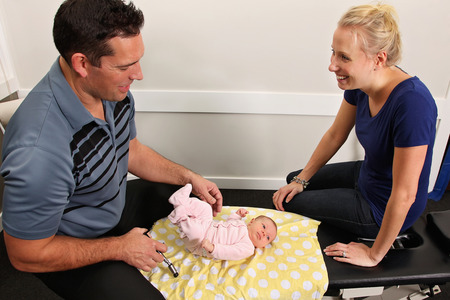 A chiropractor treating a new born babyの写真素材