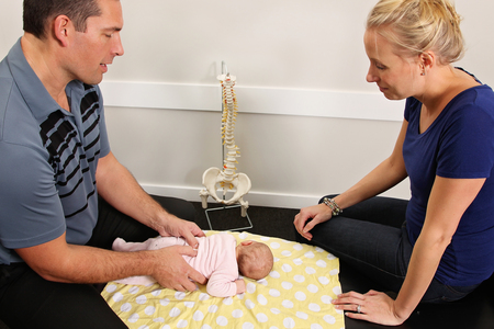 A chiropractor treating a new born babyの写真素材