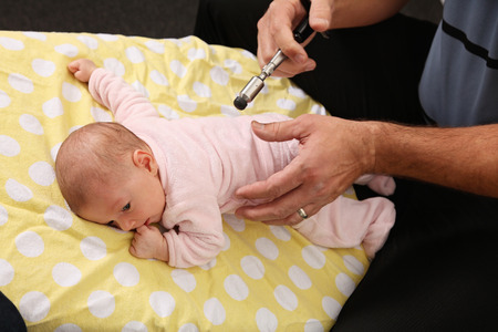 A chiropractor treating a new born babyの写真素材