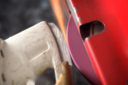 Hockey skate getting sharpened on a machineの写真素材