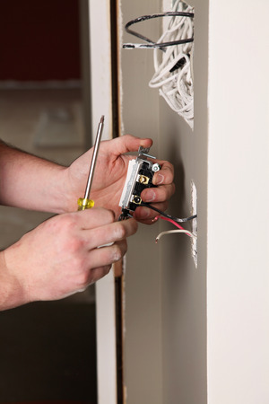 An Electrician working on a new construction siteの写真素材