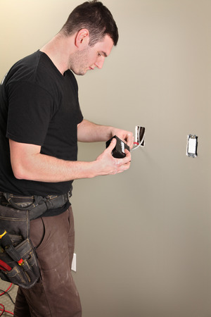 An Electrician working on a new construction siteの写真素材