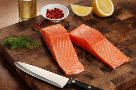 closeup of a salmon fillet on a cutting boardの写真素材