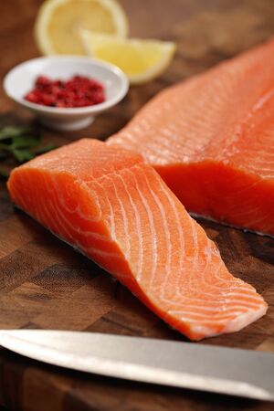 closeup of a salmon fillet on a cutting boardの写真素材