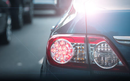 A tail light of the blue car on the street with movie lighting effect.の写真素材