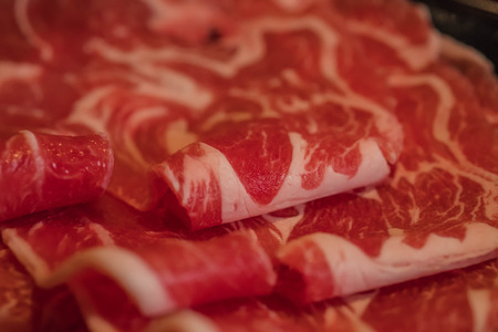 Raw fresh lamb meat slice in close up shot. Marbling lamb sirloin in macro mode.の写真素材