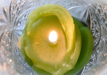 Close up melt green wax with candle light, Green and lighting in twinkle jar.の写真素材