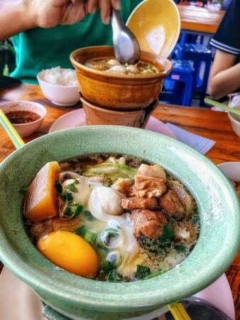 Braised pork noodles with egg on the hot potの写真素材