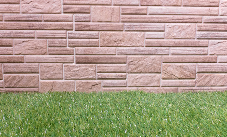 Brick wall made from laminate material with grass.の写真素材