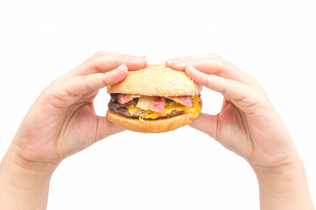 Female hand holding burger in isolate background.の写真素材