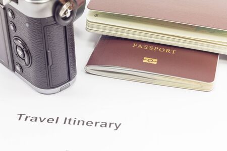 Passport and camera on travel itinerary paper : can use this for tourism concept.の写真素材
