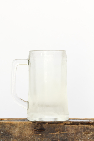 Cool empty glass beer on wood with white background.の写真素材