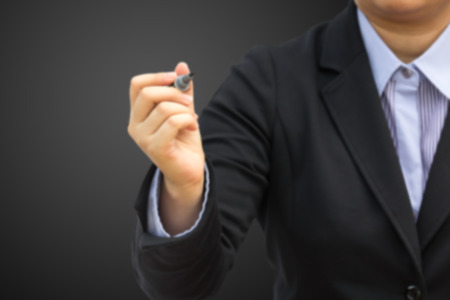 Blurred businesswoman holding marker : Can use for business background concept.の写真素材