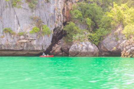Blurred kayaking with big rock background : Holiday and summer background concept.の写真素材