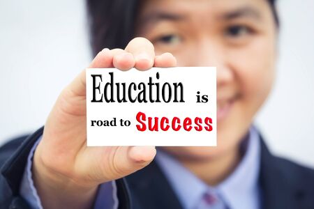 Businesswoman holding card with Education is road to Success message.の写真素材