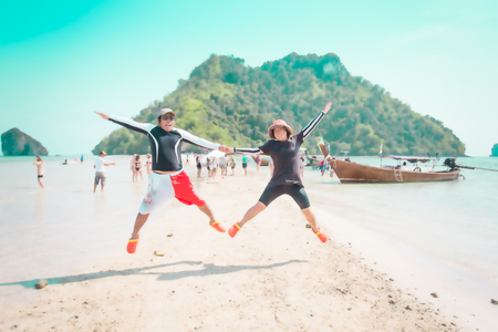 Blurred couple happy with jumping on the beach : Holiday and summer concept background.の写真素材