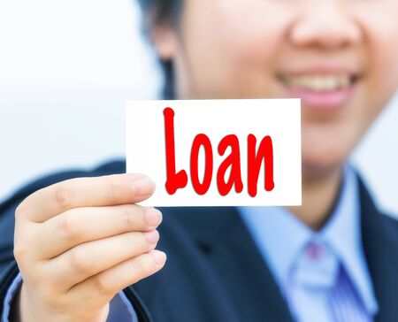 Businesswoman holding card with loan message.