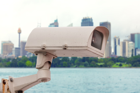 Dirty CCTV security camara with blurred office building background.の写真素材