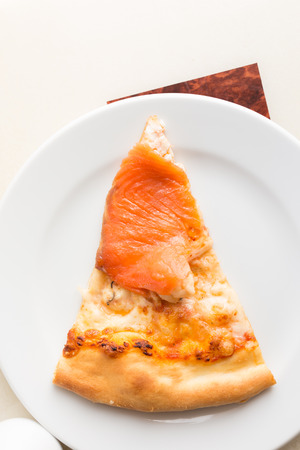 Pizza salmon and seafood on white disk.の写真素材