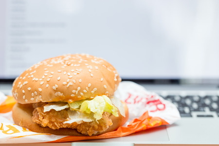 Burger on laptop in office with copy space background.の写真素材