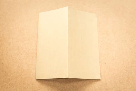 White paper note on business wood desk with copy space.
