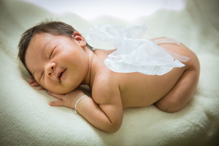 Baby cute girl sleep with smiling on mattress.の写真素材