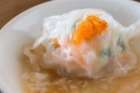 Streamed crab meat and vegetables dumpling with white egg sauce.の写真素材