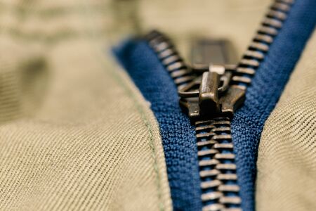 Old metal zipper openning on pants. (Selected focus)の写真素材