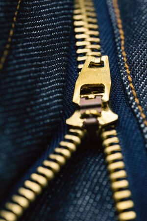 Close up metal zipper openning on blue jean. (Selected focus)の写真素材